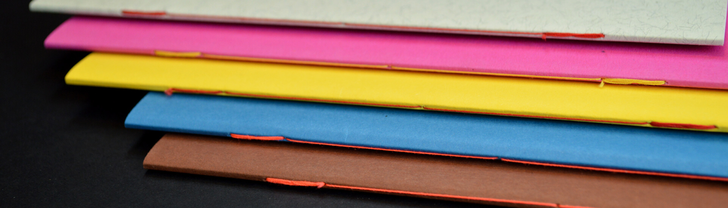 Booklets with thread back-stitch binding in five colors