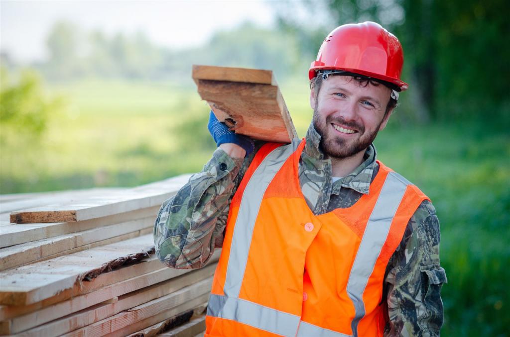 Construction worker carrying wooden boards