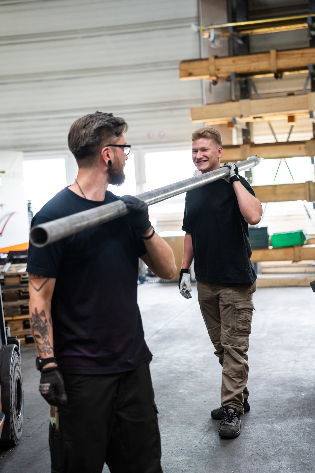 Transport of a long metal pipe in the workshop
