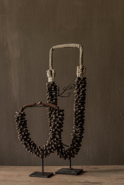 Decorative olive shell garland on stand