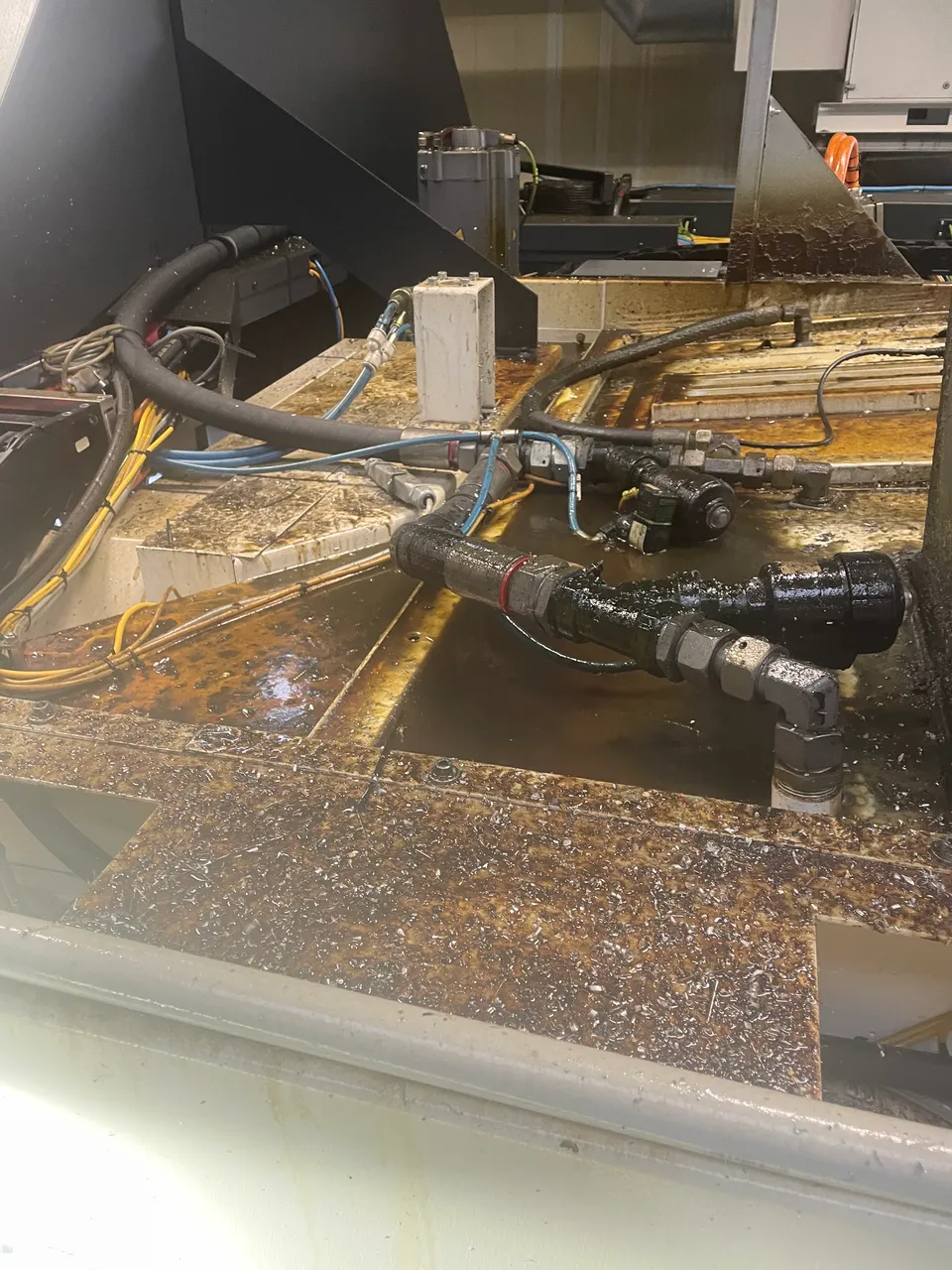 Machine enclosure with contaminated coolant before cleaning