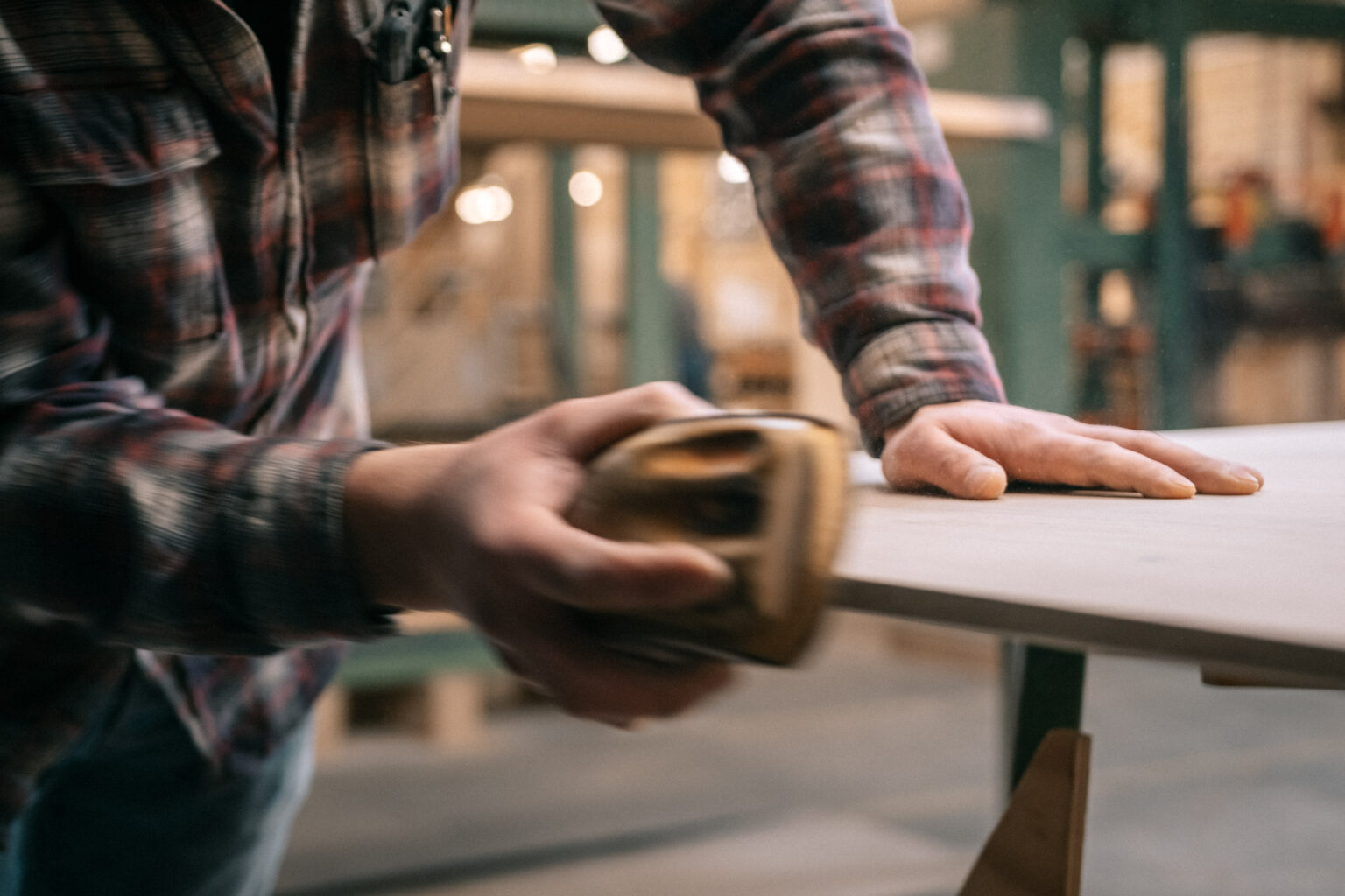 Carpenter sanding a wood edge