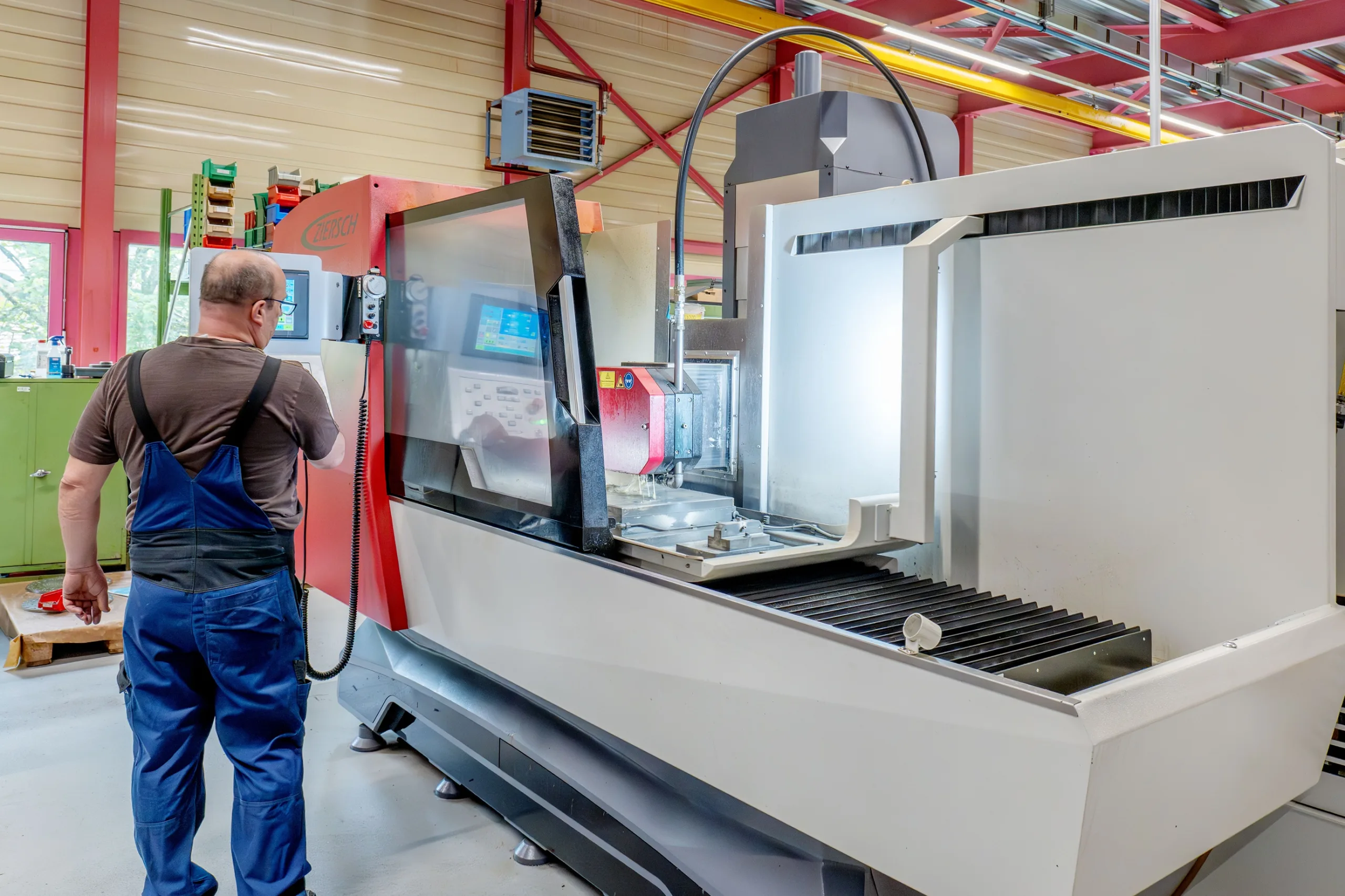 Employee setting up a surface grinding machine