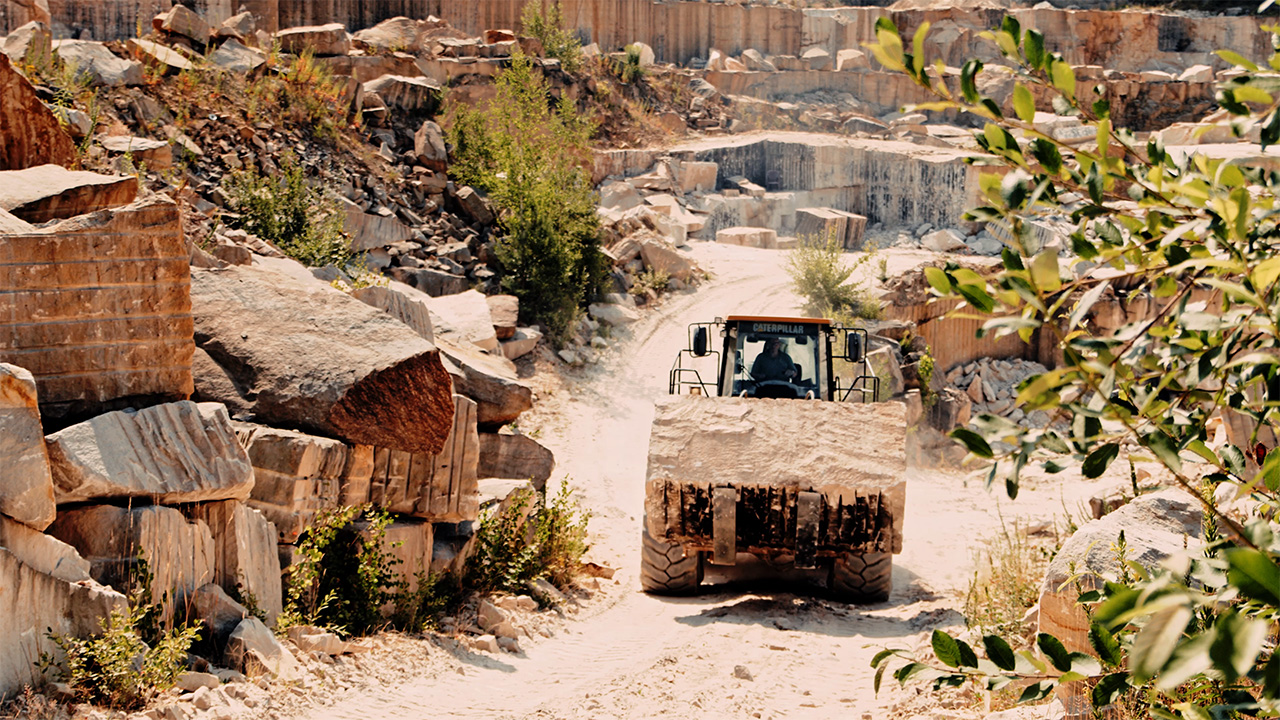 Quarry with excavator transporting sandstone away