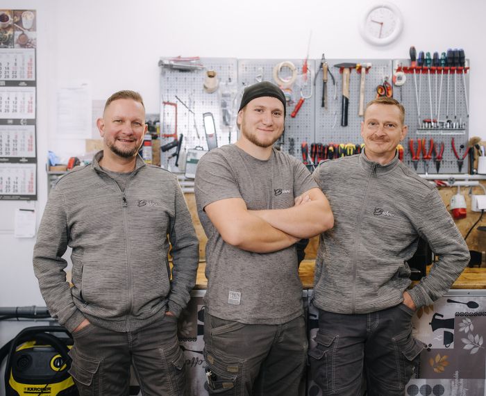 Serviceteam in der Werkstatt vor der Werkzeugwand