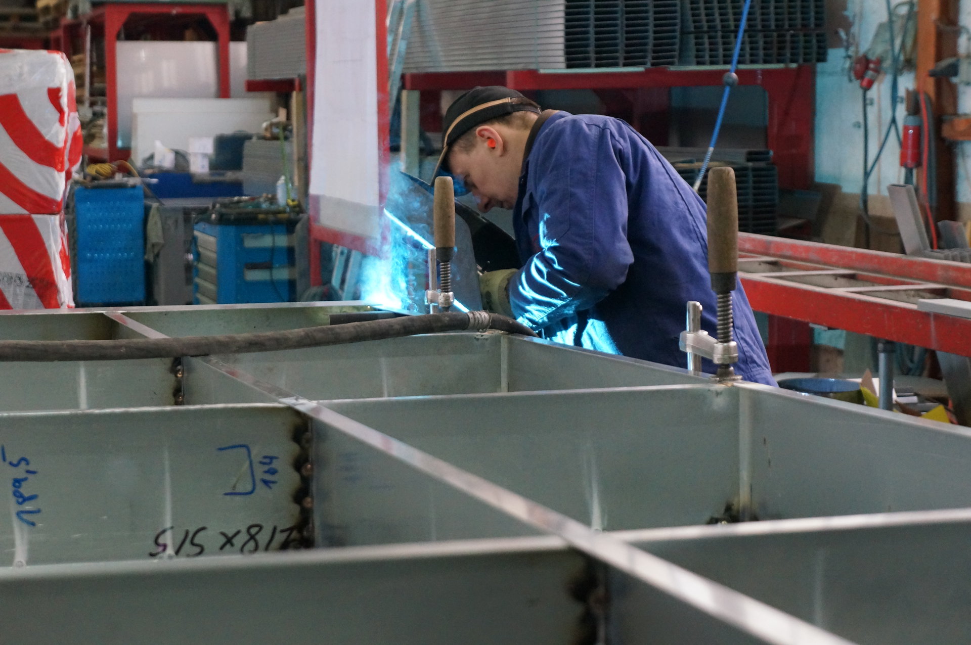 Schweißen an Stahlkonstruktion in der Werkshalle
