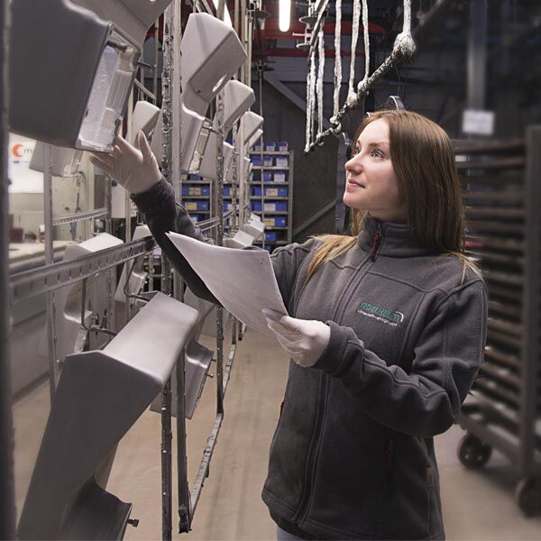 Apprentice carrying out production inspection