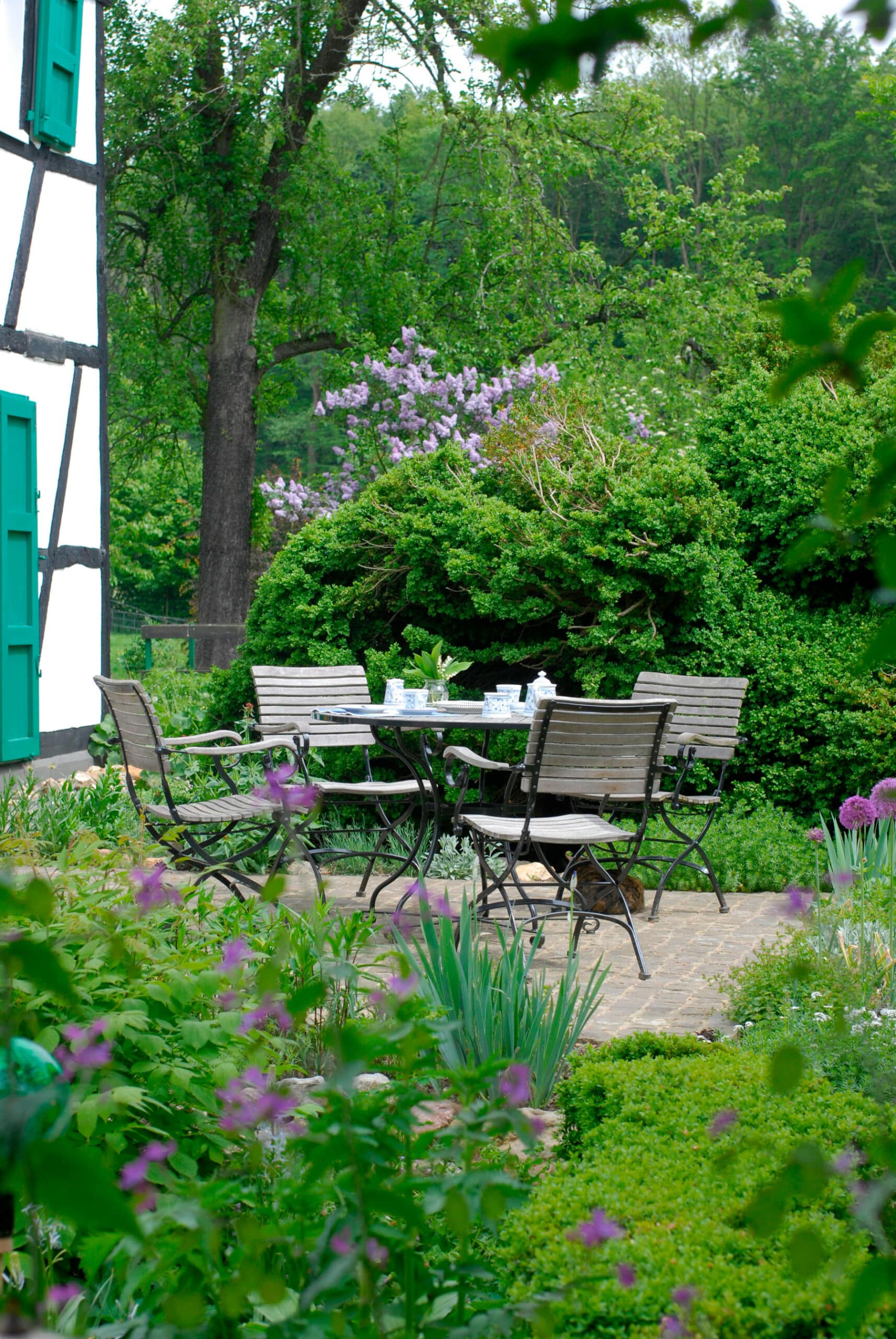 Runder Gartentisch in gestalteter Gartenanlage